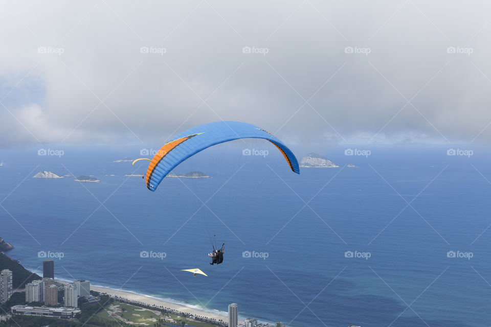 Paraglider flying over Sao Conrrado in Rio de Janeiro Brazil.