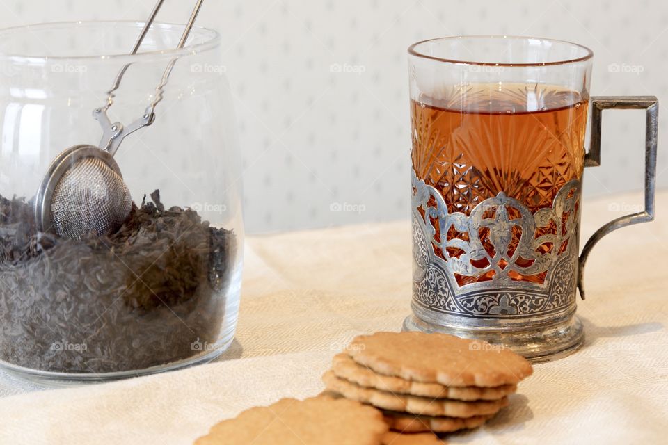 Tea in transparent glass with biscuit