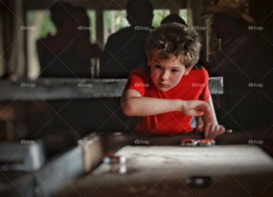 Quoits. Boy Playing Quoits Indoors
