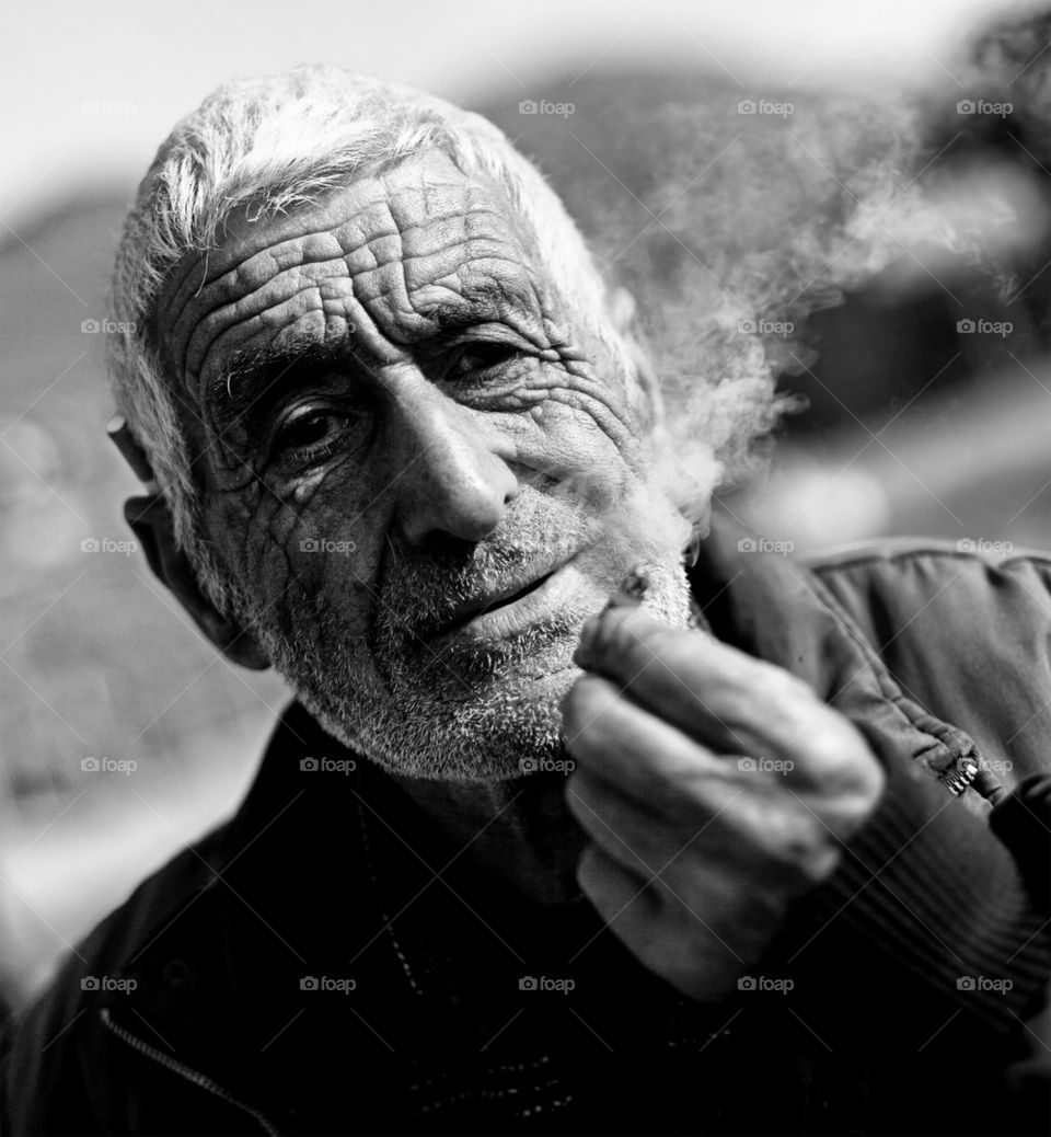 old man high contrasted black and white portrait