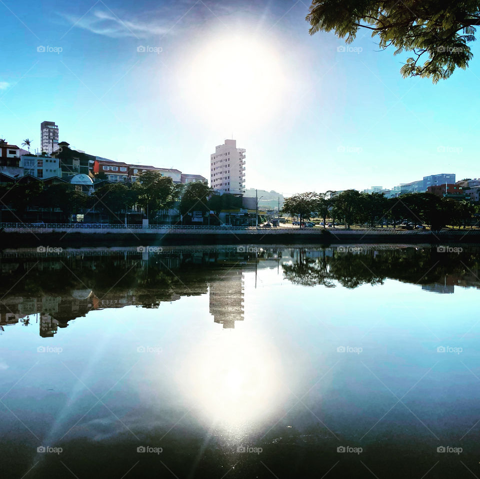 Seeing Double? 🇺🇸 The image of the neighboring buildings of Lago do Taboão in Bragança Paulista, reflected in the water. Uau, and the Sun? / 🇧🇷 A imagem dos prédios vizinhos do Lago do Taboão em Bragança Paulista, refletida na água.