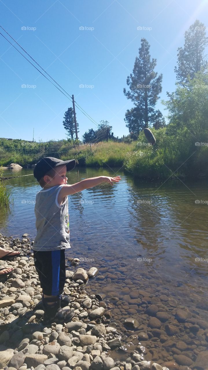 My lil guy throwing rocks into the creek for a fun family day!