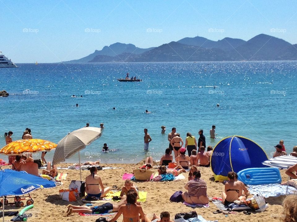 Hanging on the beach. A beach full of people ready to do a swim ,Cannes,Fr