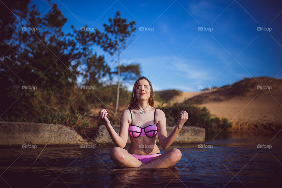 Woman meditating in lake