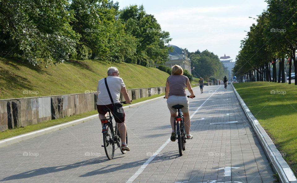 summer city view and person riding bike