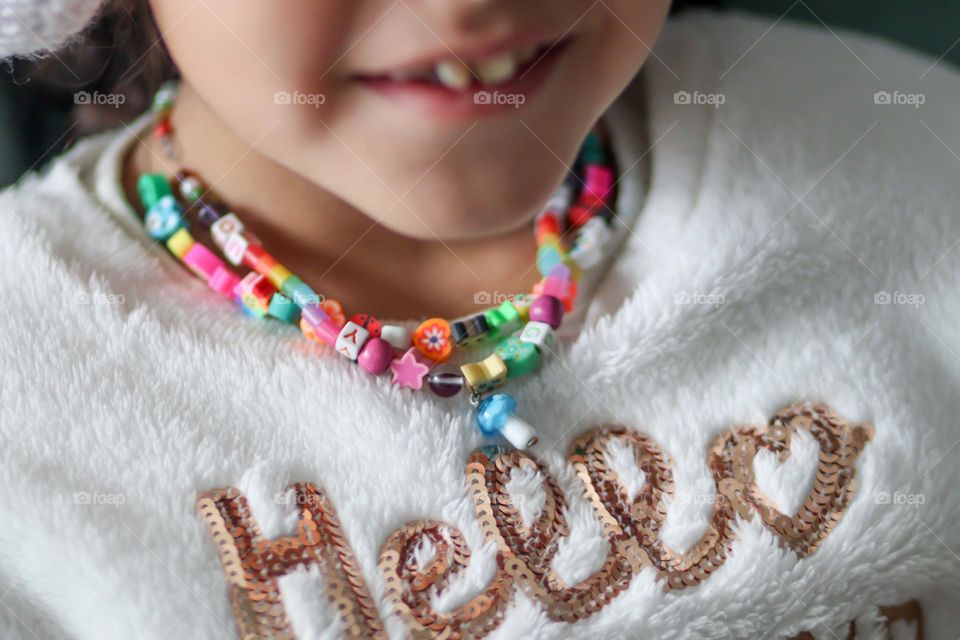 Cute little girl with a wonderful necklaces on