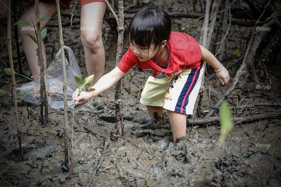 A girl is planting tree environment conservative 