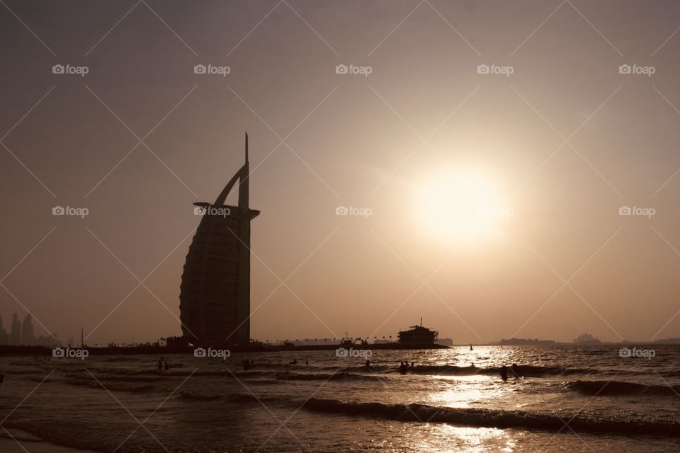 The sailing boat hotel in Dubai in the sunset from the beach 