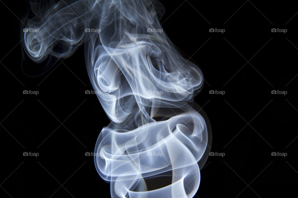 Incense smoke against black background 