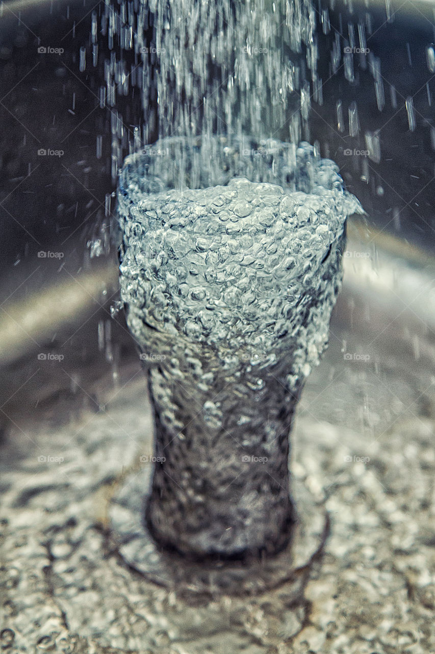 Close-up of water falling in drinking glass