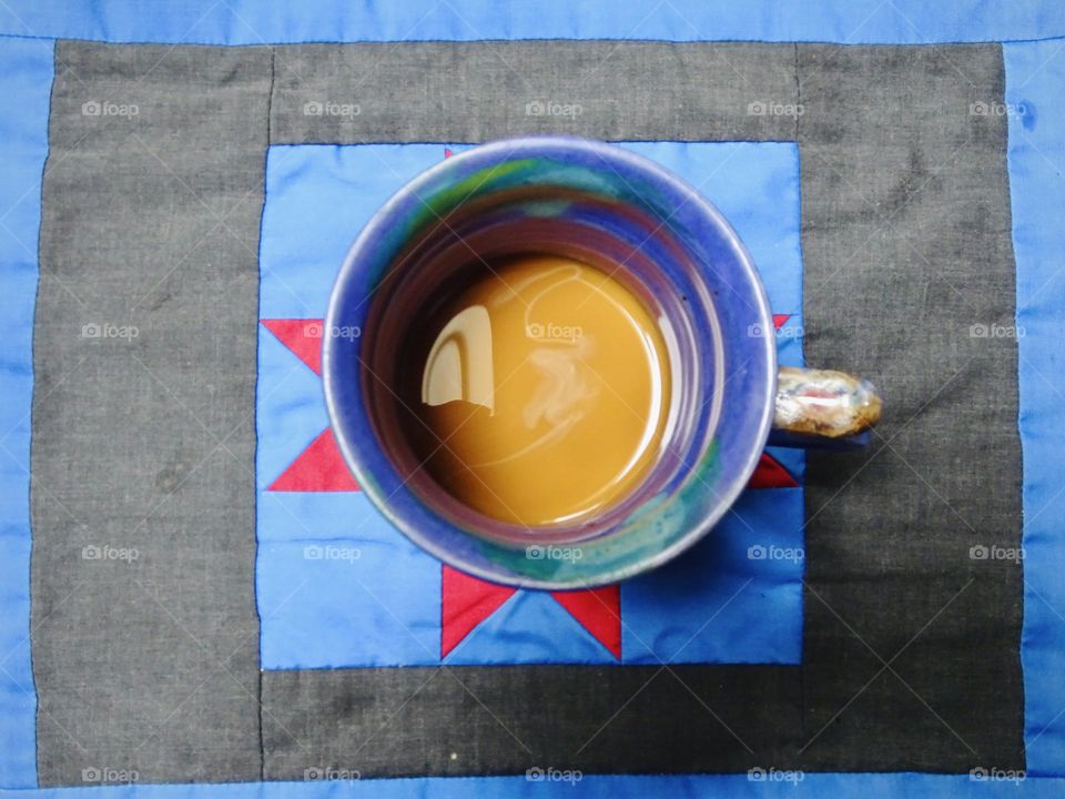 Coffee with milk in the blue mug