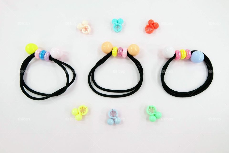 Black Rubber Band with Bead Fashion Accessories. Hair Elastic Band with Free Space. Black Hair Band with Colorful Hair Clip Isolated on Pink Background Great for Any Use.