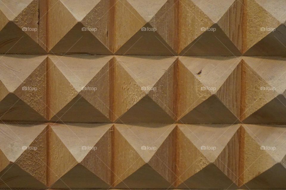 Triangular pyramid shaped on a piece of wood 