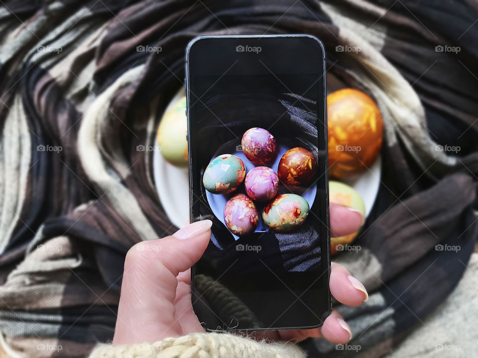 Taking a photo of handmade marble Easter eggs 