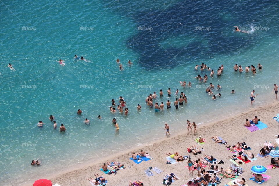 Young people enjoying the beach and the ending of the school year