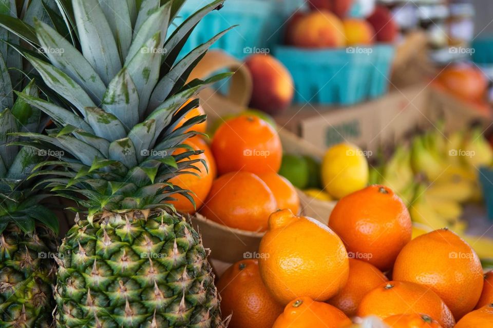 Fresh summer Fruit pineapple oranges at farmers market 