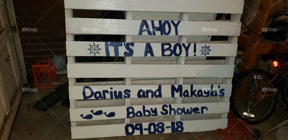 Custom sign I created from an old pallet, some stencils and some paint, for a nautical themed baby shower.