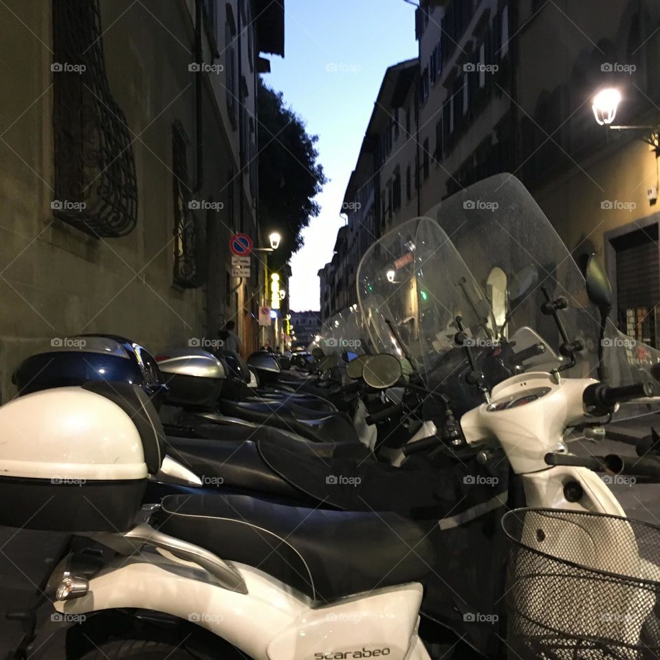 Motorbikes and mopeds parked in City street 