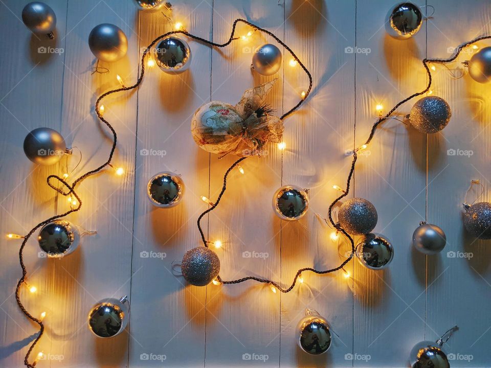 Christmas glowing garland and silver Christmas balls on a white background