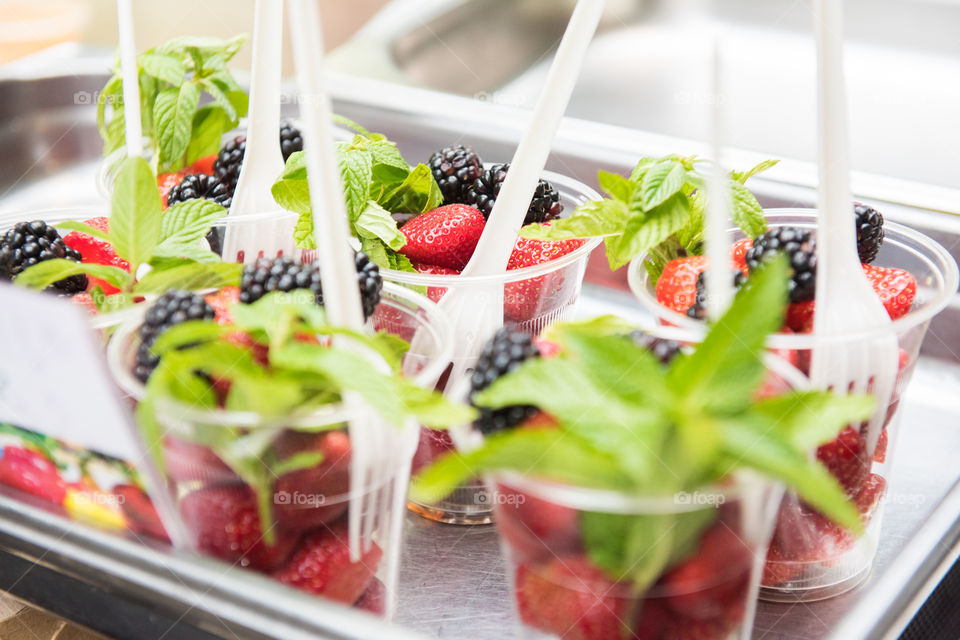 Strawberry and Blackbarry in a cup at a food market in London.