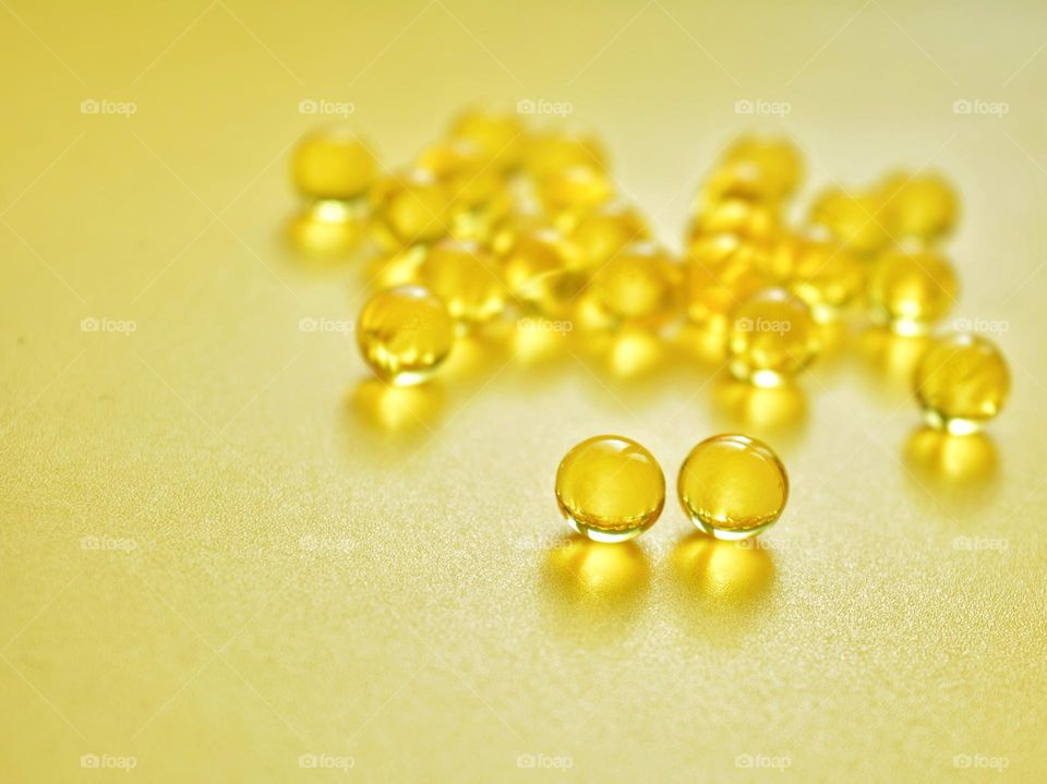 vitamins oils close up yellow background