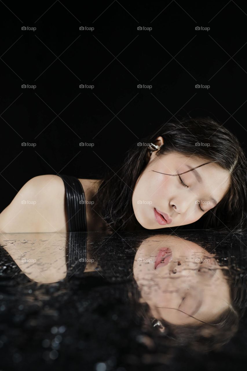 Reflection of a face on glass and water