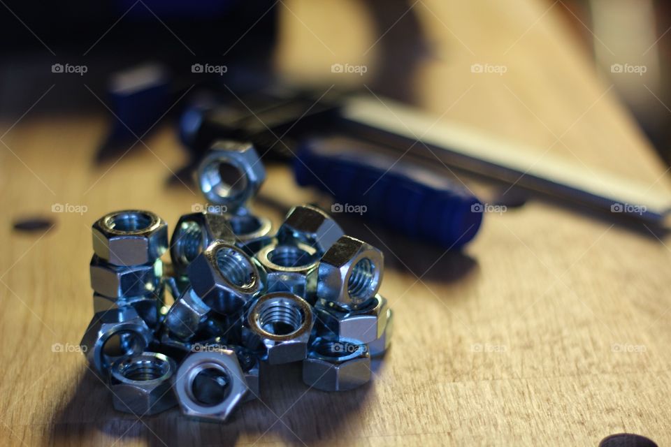 Close-up of metal nuts on wooden table