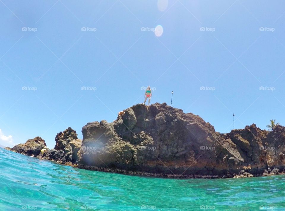 Ready to Dive. Cliff jumping off of the Black Rock in Maui, Hawaii into perfectly clear waters below