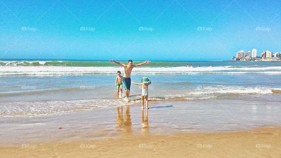 Father and children enjoying at beach