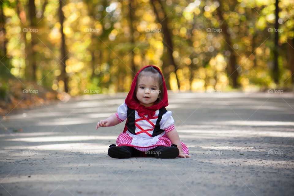 Cute girl sitting on street