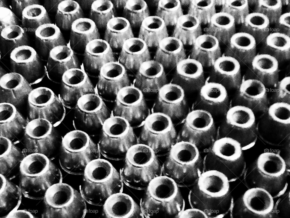 Hollow point bullets line up to make a statement in black and white 