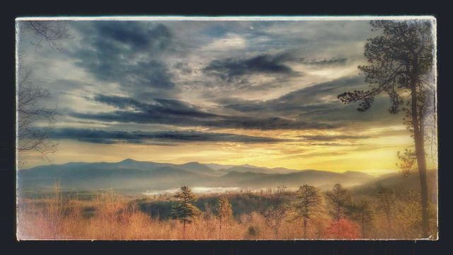 late fall in the smokey mountains, sunset sky with swirling storm clouds