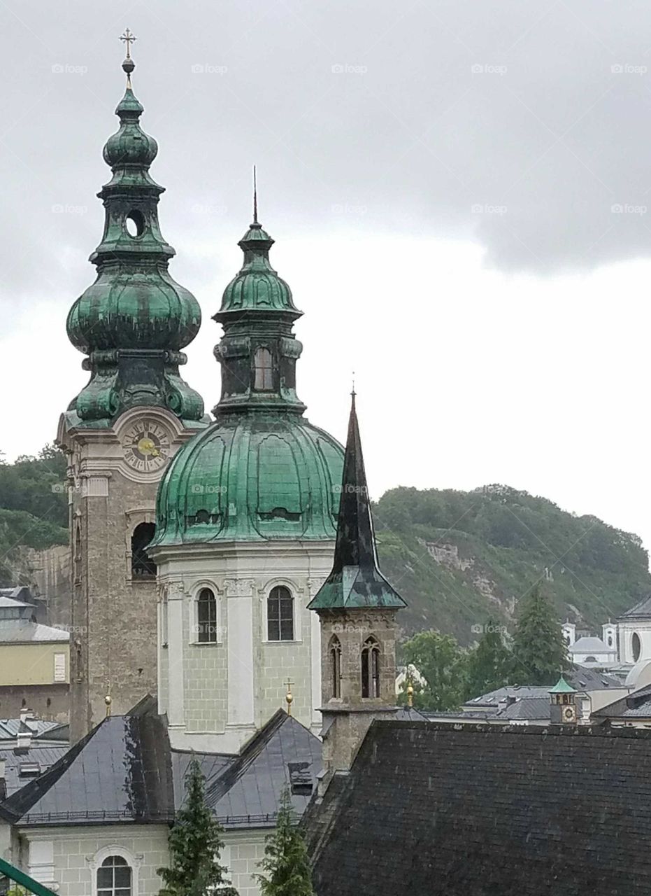 three green copper church steeples in descending heights, Salzburg, Austria