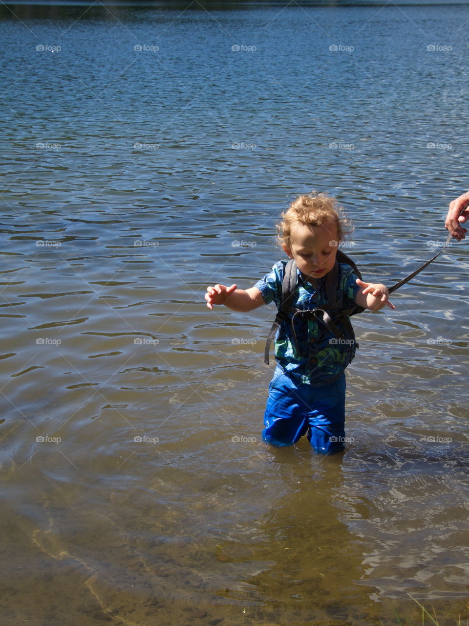 Little boy on summer vacation at high lake in Oregon forest 