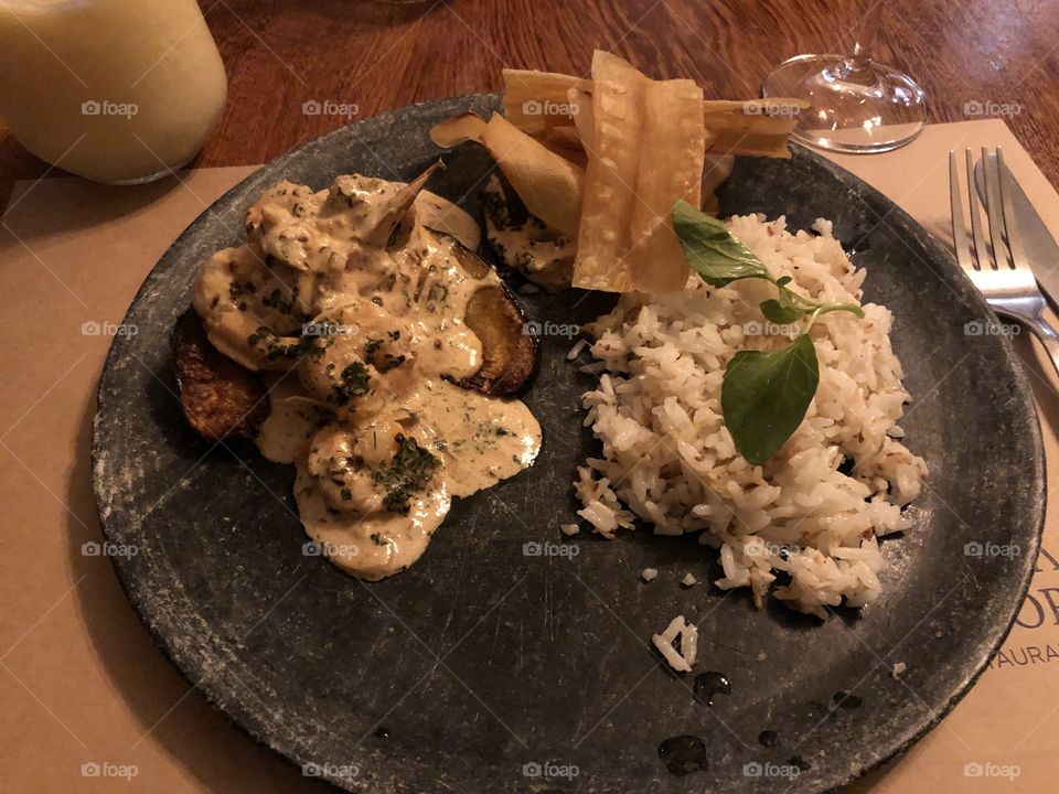 Modern dish with shrimps, mandioca chips and rice