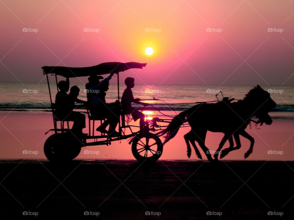 people enjoying Tonga or horse ride on the beach during sunset