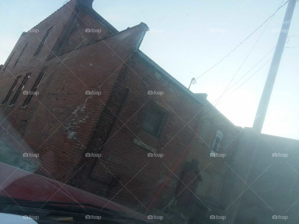love old buildings trees and clouds red brick over 100 years old poor Iowan food bank