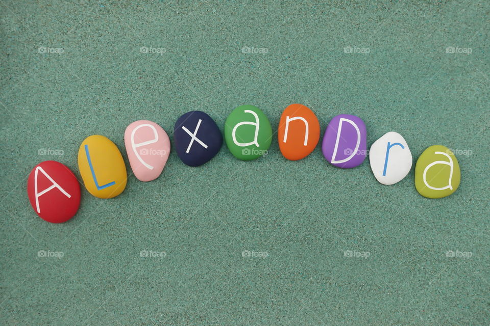 Alexandra, feminine given name composed with colored sea stones over green name