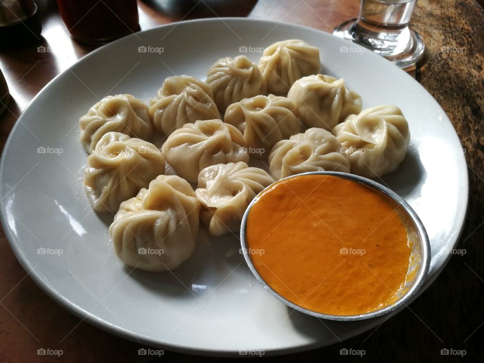 Momo one of the most popular food in Nepal filled with chicken. on the side is Nepalese style tomato chutney! #yummy