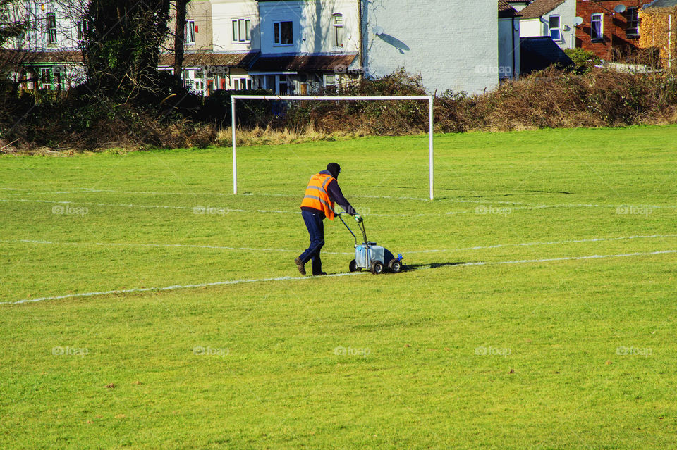 Cutting grass. Groundsman 