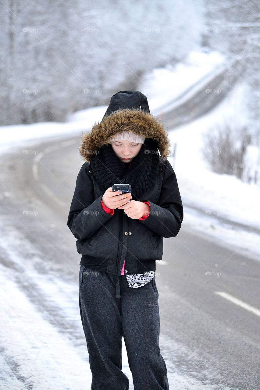 Small boy looking in mobile phone