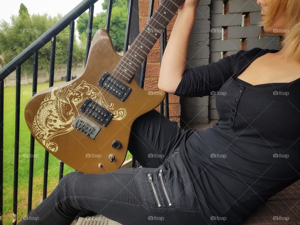 Female holding an Electric Guitar