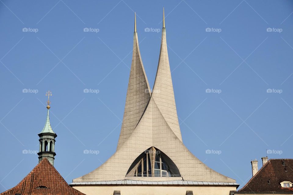 Benedictine monastery Emauzy - Emmaus Monastery. Frontal view. Architectural monument from fourteen century with two modern spiky towers on sunny day, Prague, Czech Republic.