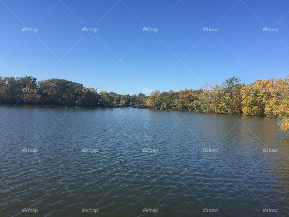 Fall day on a Minnesota Lake with the leaves starting to turn on the shoreline 