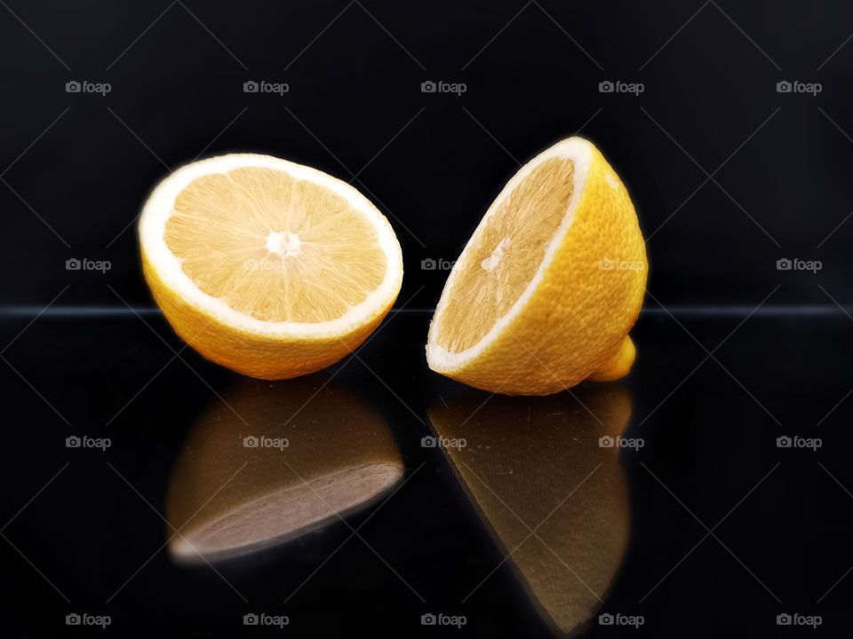 reflection on black glass of lemon slices