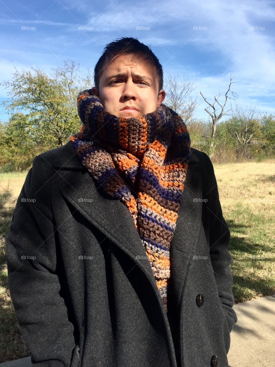 Man modeling a hand crocheted scarf 