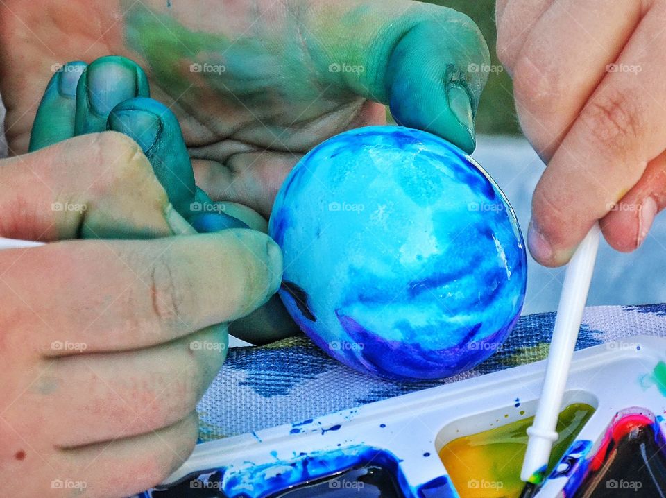 Coloring An Easter Egg. Coloring An Easter Egg In Blue Dye
