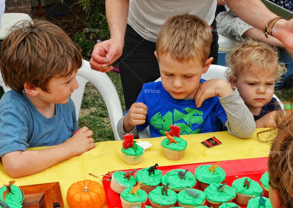 Birthday Cupcakes. Young Children Enjoying Cupcakes At A Birthday Party
