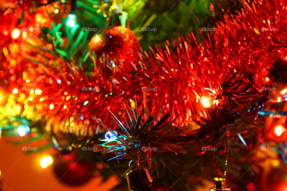 Macro shot of Christmas tree decorations and vivid lights