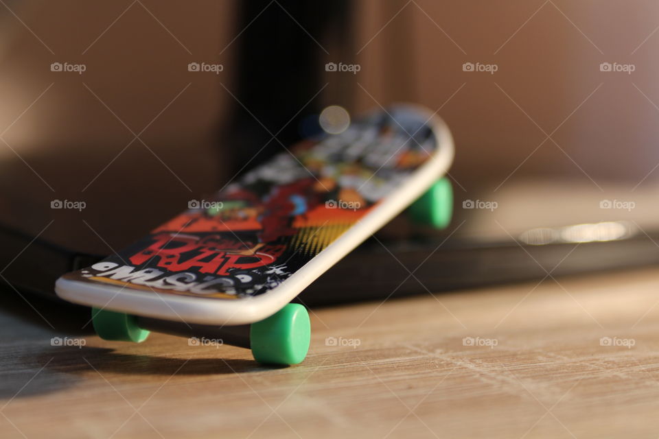 miniature skateboard toy close-up with graffiti on it